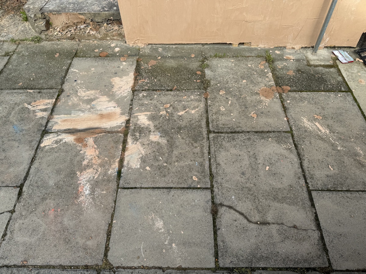 Plaster on the pavement outside the property